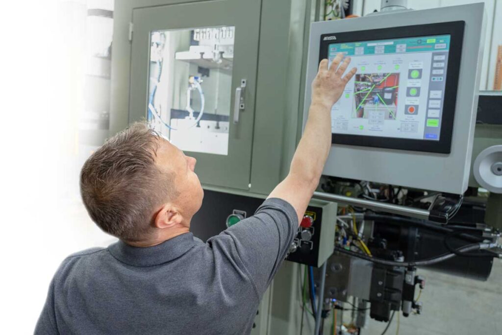 Employee working with high-tech precision machinery.