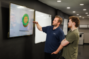 precision resource employees collaborating at a white board